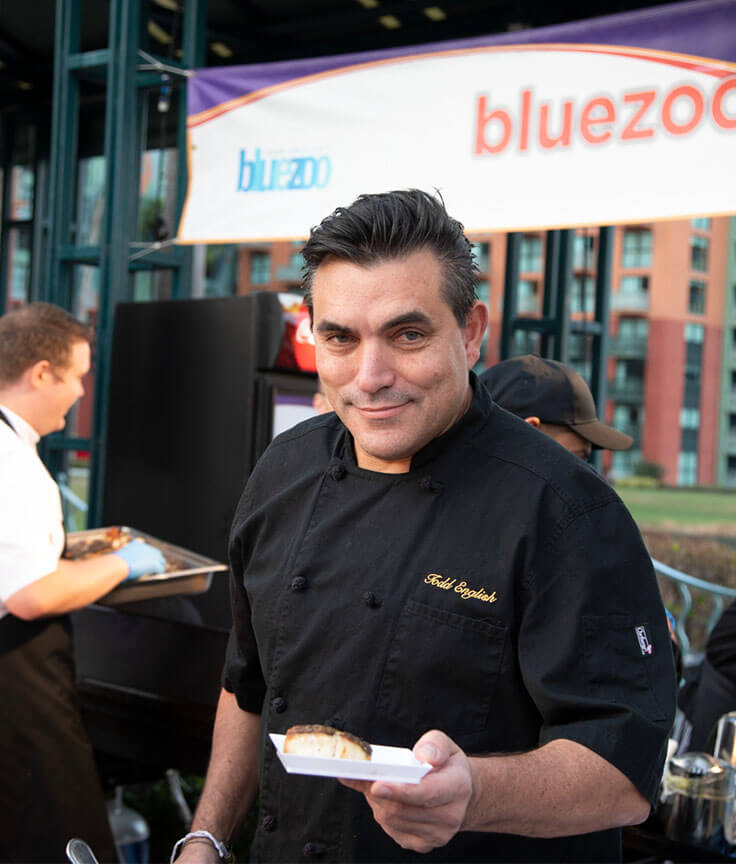 Chef Todd English holding a plate